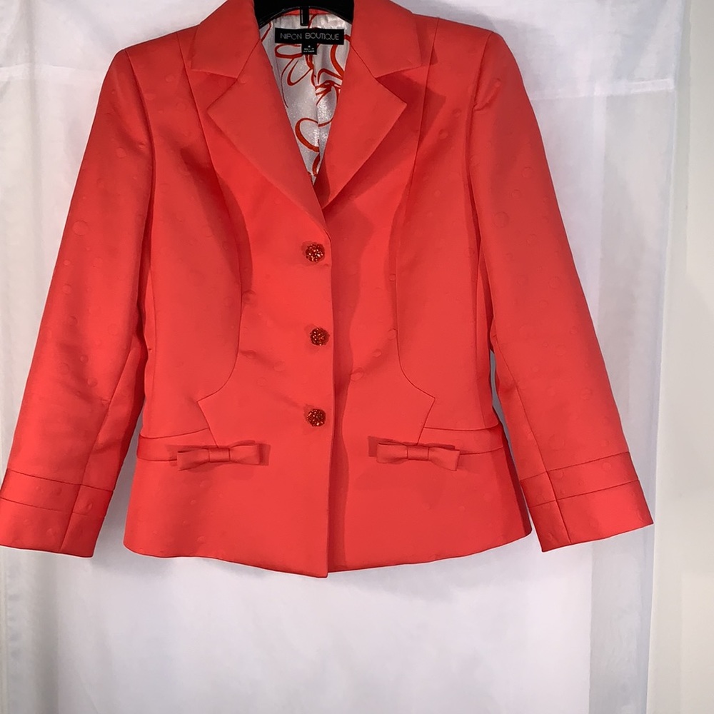 A Nipon Boutique skirt suit size 4. A beautiful citrus punch orange color.